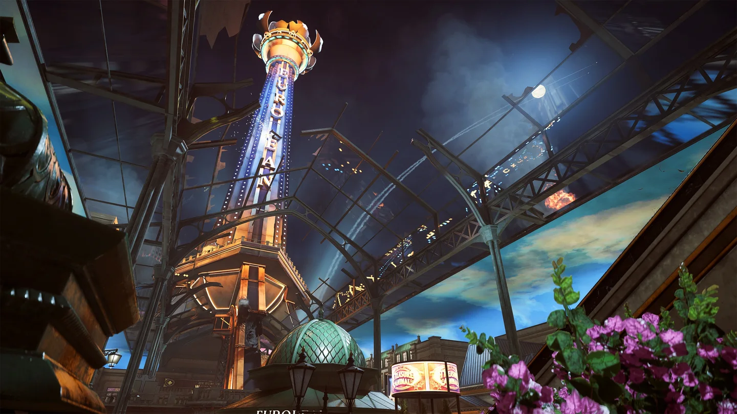 A tall, illuminated tower is visible over a broken, glass-paneled roof at night. An explosion is seen in the sky outside.